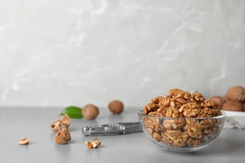 Composition with walnuts in bowl on table. Space for text Stock Photos