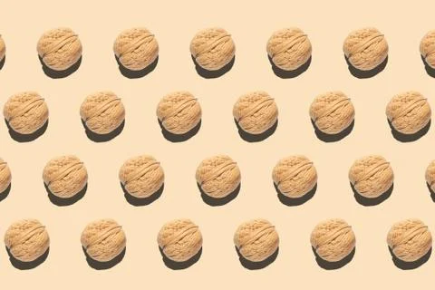 Composition with walnuts pattern on light brown background Stock Photos
