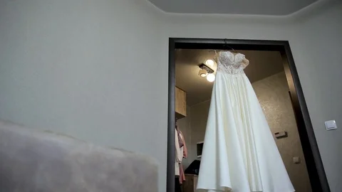 Composition - wedding dress on a gray blue wall with decor and accessories. Stock Footage 105463218