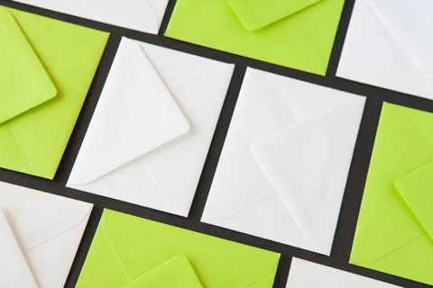 Composition with white and green envelopes on the table. 库存照片