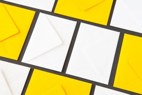 Composition with white and yellow, envelopes on the table. 库存照片