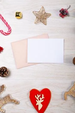 Composition of white card with copy space, envelope and christmas decorations on Stock Photos