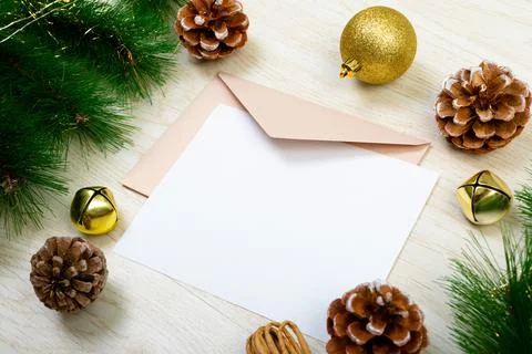 Composition of white card with copy space, envelope and christmas decorations on Stock Photos