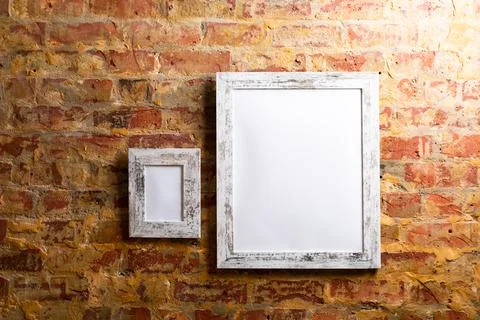 Composition of white cards in frames with copy space and decorations on brick Foto stock