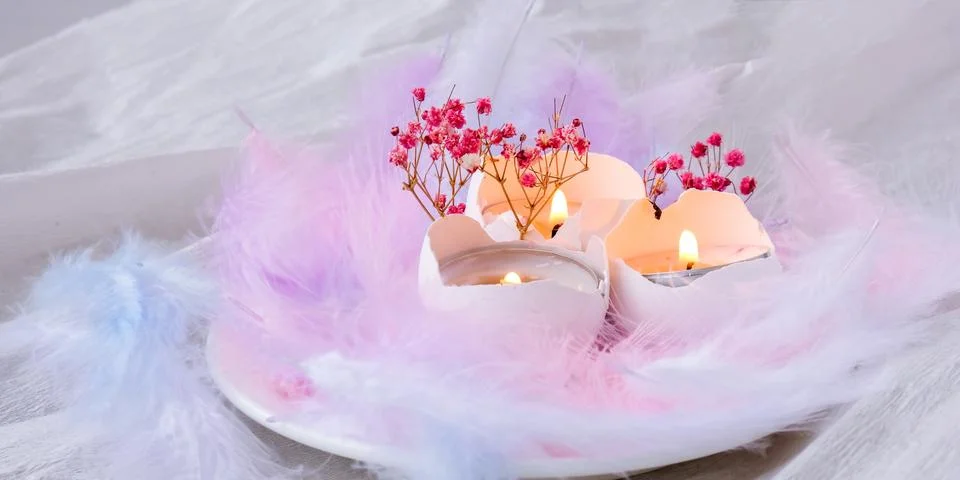 Composition of White egg shell with candle inside. Candle light. Bright easte 写真素材