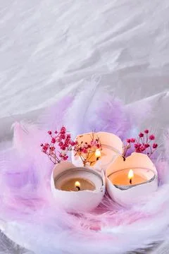 Composition of White egg shell with candle inside. Candle light. Bright easte Stockfoto's