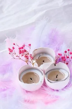 Composition of White egg shell with candle inside. Bright easter decorations  Stockfoto's