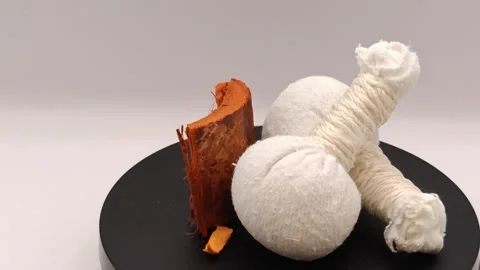 Composition of white herbal massage bags swirling in large circles Stock Footage 323762034