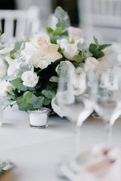 Composition with white roses on a gray table. Wedding decor Stock Photos