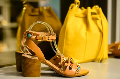 The composition in the window of a boutique: women's open toe shoes with a heel Stock Photos