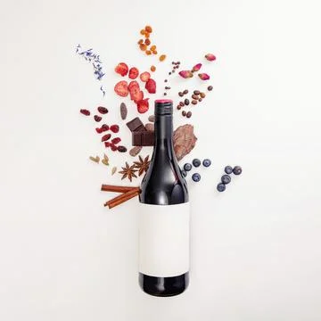 Composition with wine bottle and possible flavor components of red wine Stock Photos