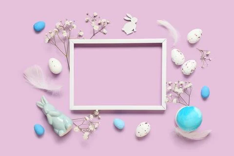 Composition with wooden photo frame, Easter eggs, feathers and gypsophila flo Stock Photos