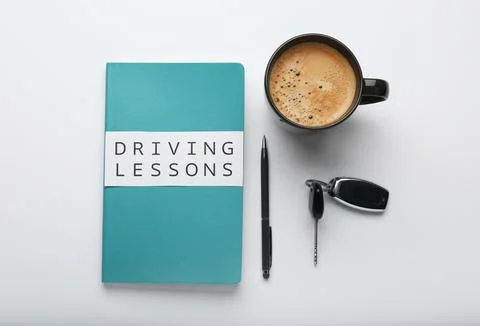 Composition with workbook for driving lessons on white background, top view.  Stock Photos