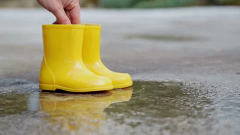 Composition of yellow rubber children's boots. Video stock 153436149