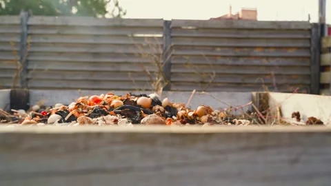 Compost heap on a suburban plot for processing organic waste into high-quality Vídeos de archivo 307269877