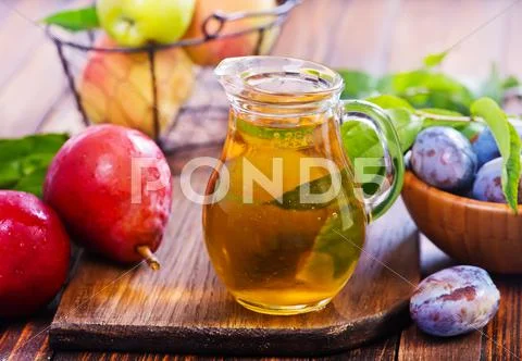 Compot in glass jug on a table Stock Photos
