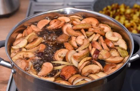 Compote of dried fruit apples is cooked in a pan with water, close up Stock Photos