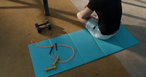A Comprehensive Fitness Routine Featuring Weights and a Jump Rope Utilized on Stock Footage 317756208