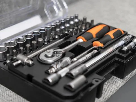 Comprehensive tool set containing various sockets, screwdriver bits, and a .. Stock Photos