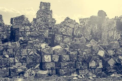 Compressed aluminium scrap in large cubes forming landfill in piles. Stock Photos