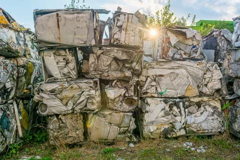 Compressed aluminium scrap in large cubes forming landfill in piles. Stock Photos