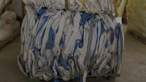 Compressed bale of used bulk bags at plastic recycling factory Stock Footage 334281095
