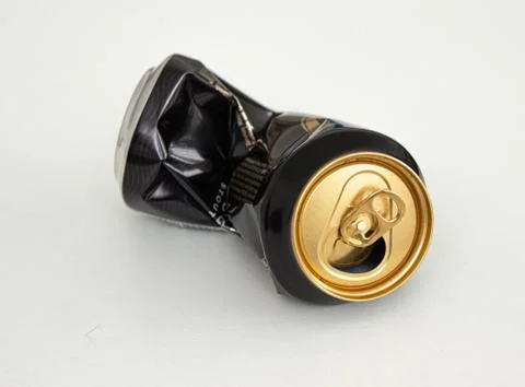 Compressed can isolated on a white background, Aluminum recycling old cans. Stock Photos