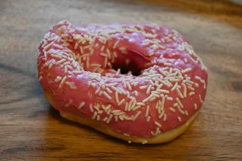 Compressed donut with pink icing and sprinkles 스톡 사진