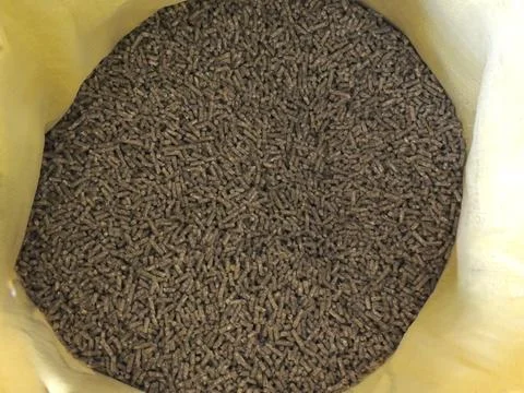 Compressed feed pellets in a yellow bag Stock Photos