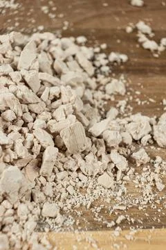 Compressed fresh yeast cubes close-up on a wooden background. Stock Photos