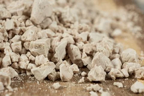 Compressed fresh yeast cubes close-up on a wooden background. Stock Photos