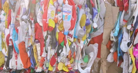 Compressed plastic packaging, colored bottles with caps. Storage, disposal and Stock Footage 156079851