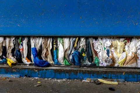 Compressed Plastic Waste Inside Recycling Press Machine at Waste Processing Photos