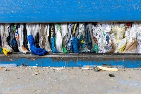 Compressed Plastic Waste Inside Recycling Press Machine at Waste Processing Stock Photos