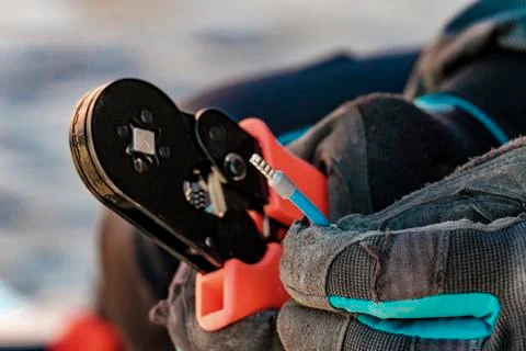 Compressed tool tip wire. Work of the electrician. Stock Photos