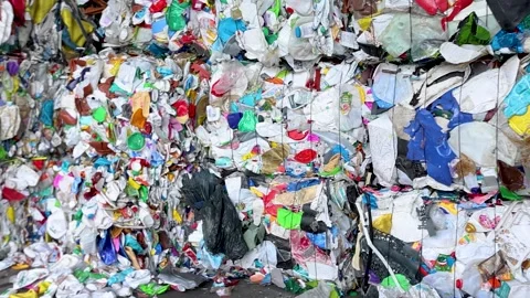 Compressed waste bales prepared for recycling transport Stock Footage 333345236