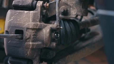 Compressing caliper piston with tool while fluid leaking during disc system Stock Footage 335368832