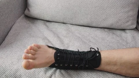 Compression ankle stabilizer bandage. Leg injury and sprain of young sportsman Stock Footage 171888339