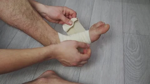 Compression ankle stabilizer bandage. Leg injury and sprain of young sportsman Stock Footage 172220341