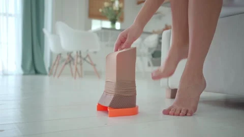 Compression stocking on assist device ready for woman to put on at home Stock Footage 321708169