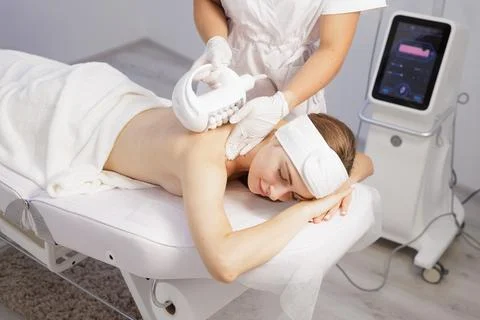 Compressive microvibration back massage with roller device in spa clinic Stock Photos