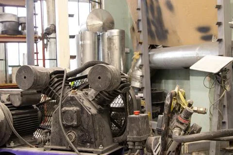 The compressor is on the floor in the painter's workshop, workshop Stock Photos