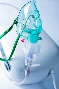 Compressor nebulizer with mask on table Stock Photos