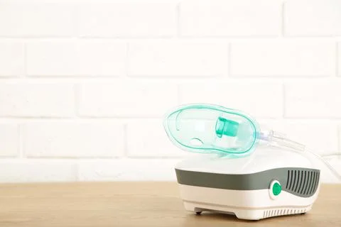 Compressor nebulizer with mask on table. Top view Stock Photos