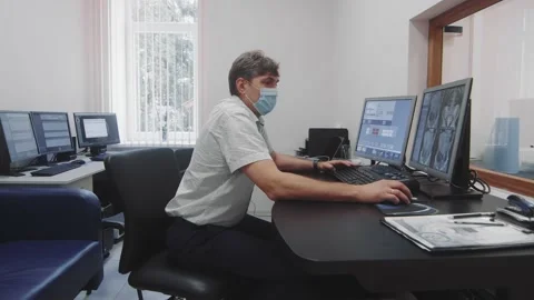 Computed tomography CT. A doctor looking at scanned parts of the body on a Video stock 171716112