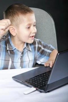 Computer addiction child with laptop notebook Stock Photos