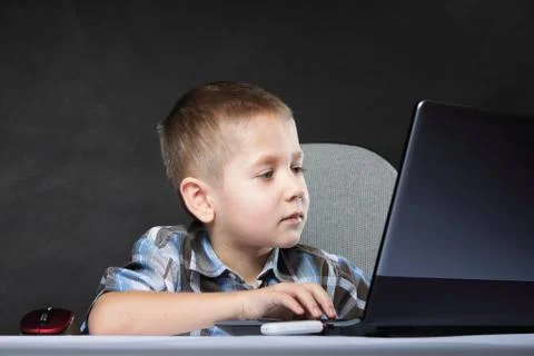 Computer addiction child with laptop notebook Stock Photos