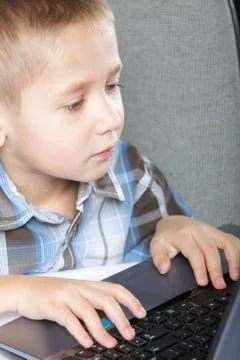 Computer addiction child with laptop notebook Stock Photos