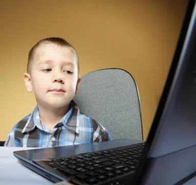 Computer addiction child with laptop notebook Stock Photos