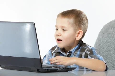 Computer addiction child with laptop notebook Stock Photos